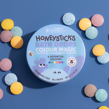 Honeysticks Bath Drops in a bright, recyclable tin packaging, perfect for adding color to bath time adventures.